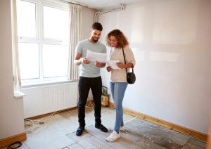 Homeowners looking at their damaged floors